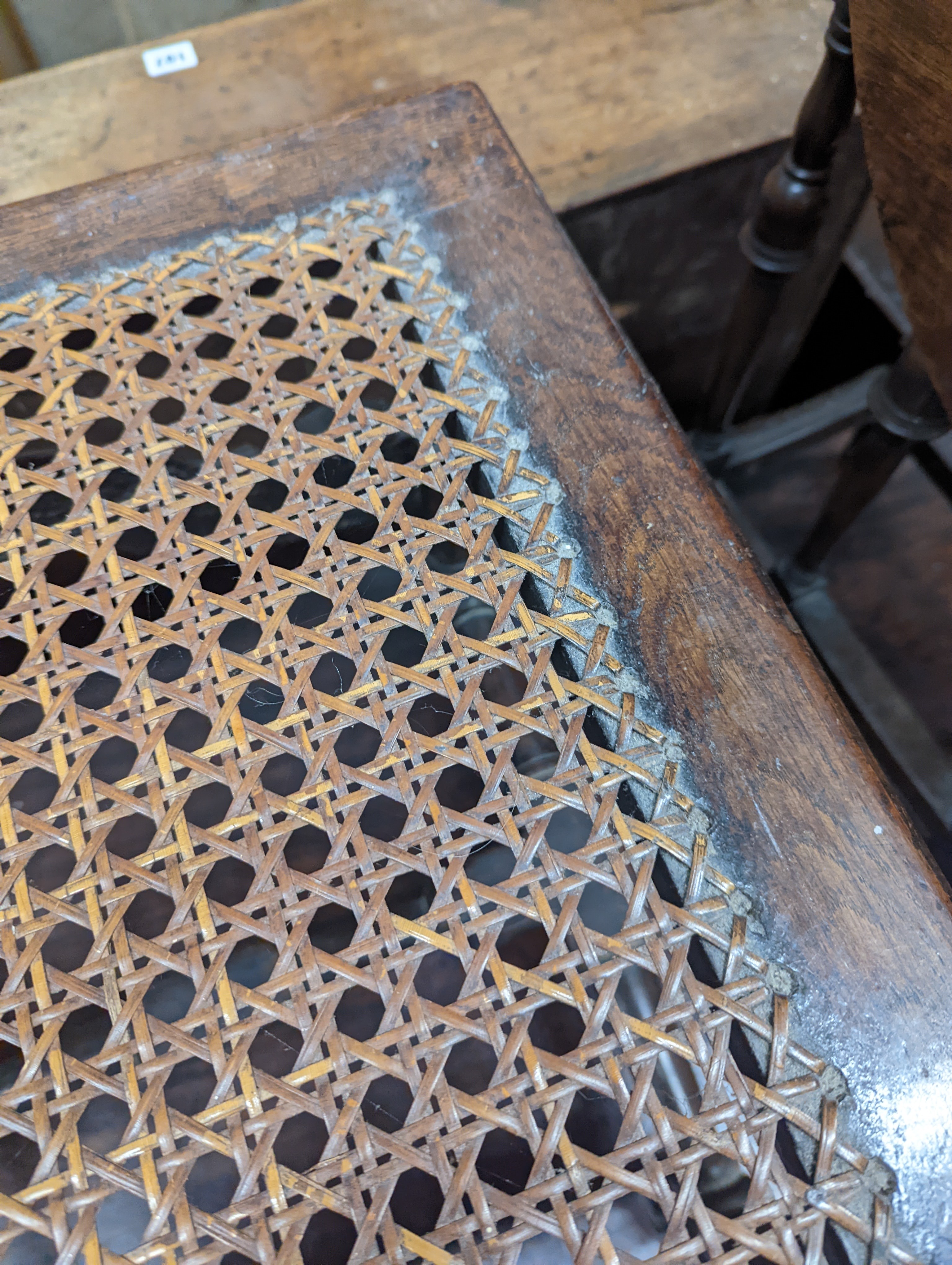 A 17th century style carved oak stool, with caned seat and H stretcher, width 47cm, depth 46cm, height 42cm